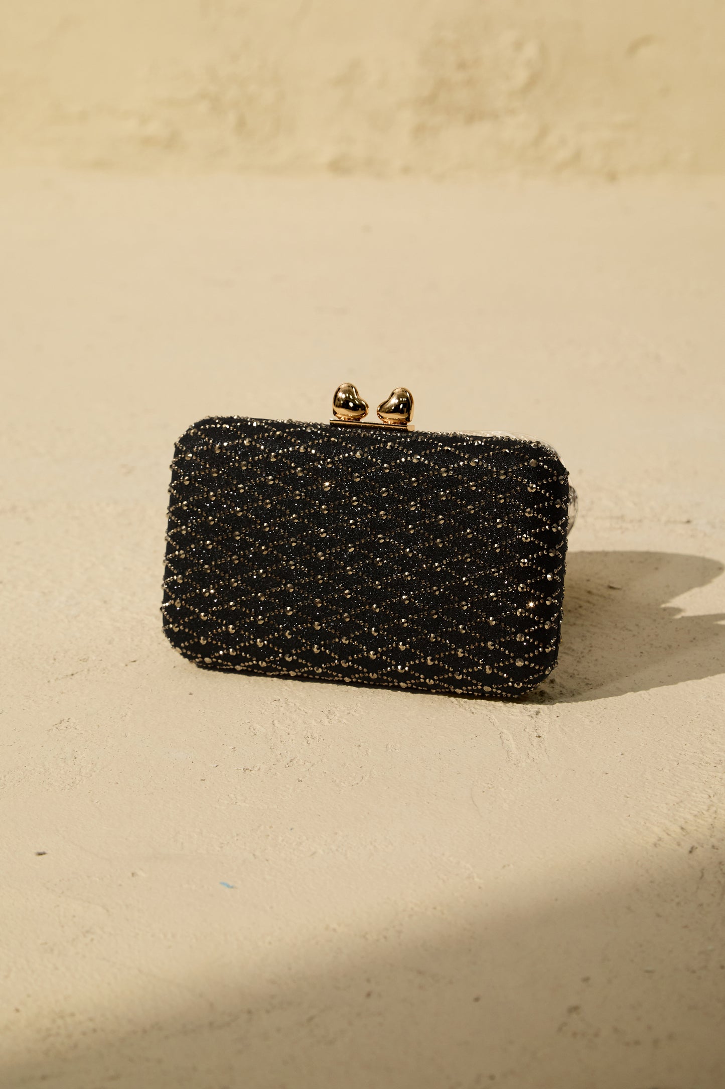 Clutch tipo caja de cristales, detalle